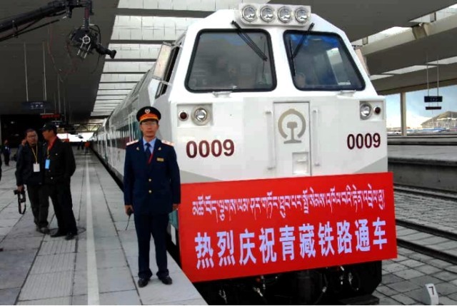 2006年7月1日,青藏铁路全线通车,铁路职工在拉萨车站首发机车前留影纪念。拉萨火车站供图